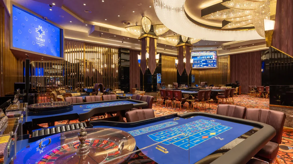 Merit Starlit Hotel Residence — casino gaming floor with roulette and card tables, interior design by ARTMİM